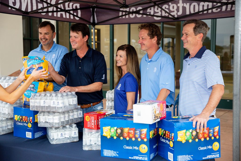 5 people standing a booth