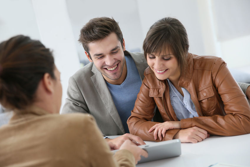 A young couple meets with a GMFS mortgage loan officer to discuss paying off their mortgage