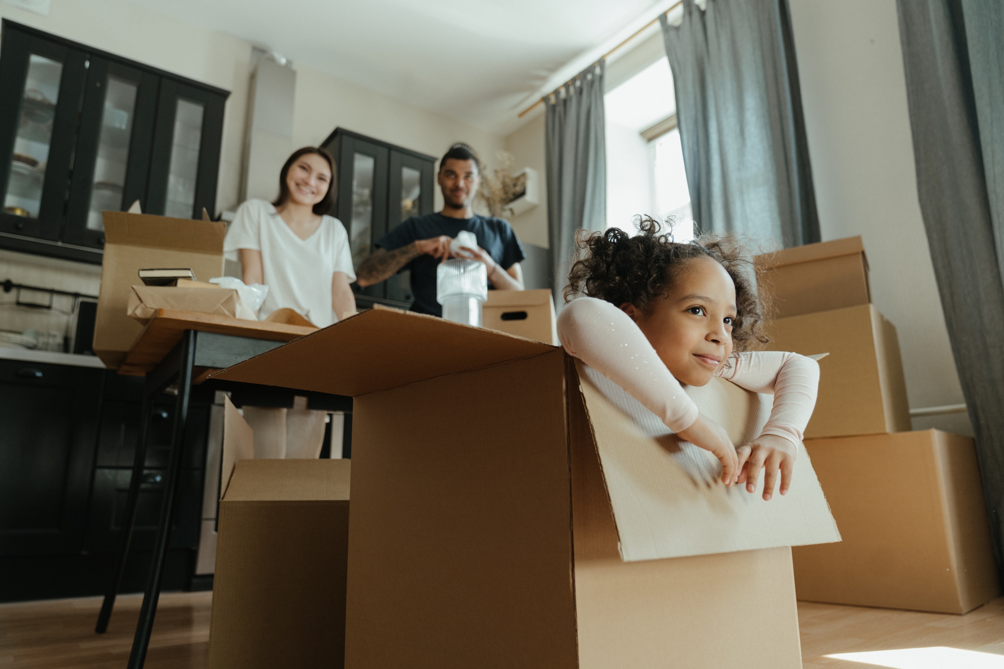 A family unpacks boxes after moving into their new home, purchased with the help of GMFS Mortgage.