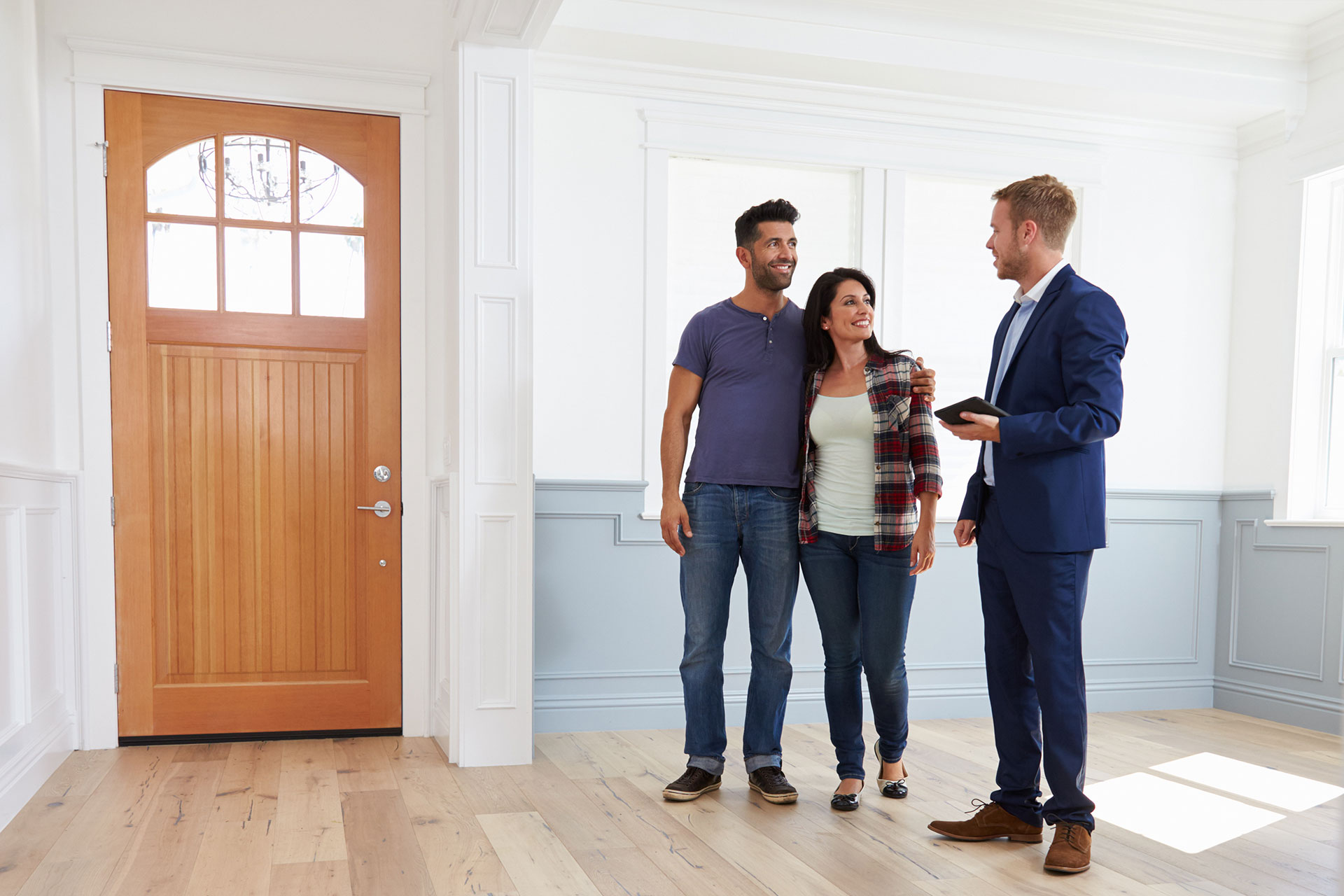 A young couple tours a house with a Baton Rouge realtor
