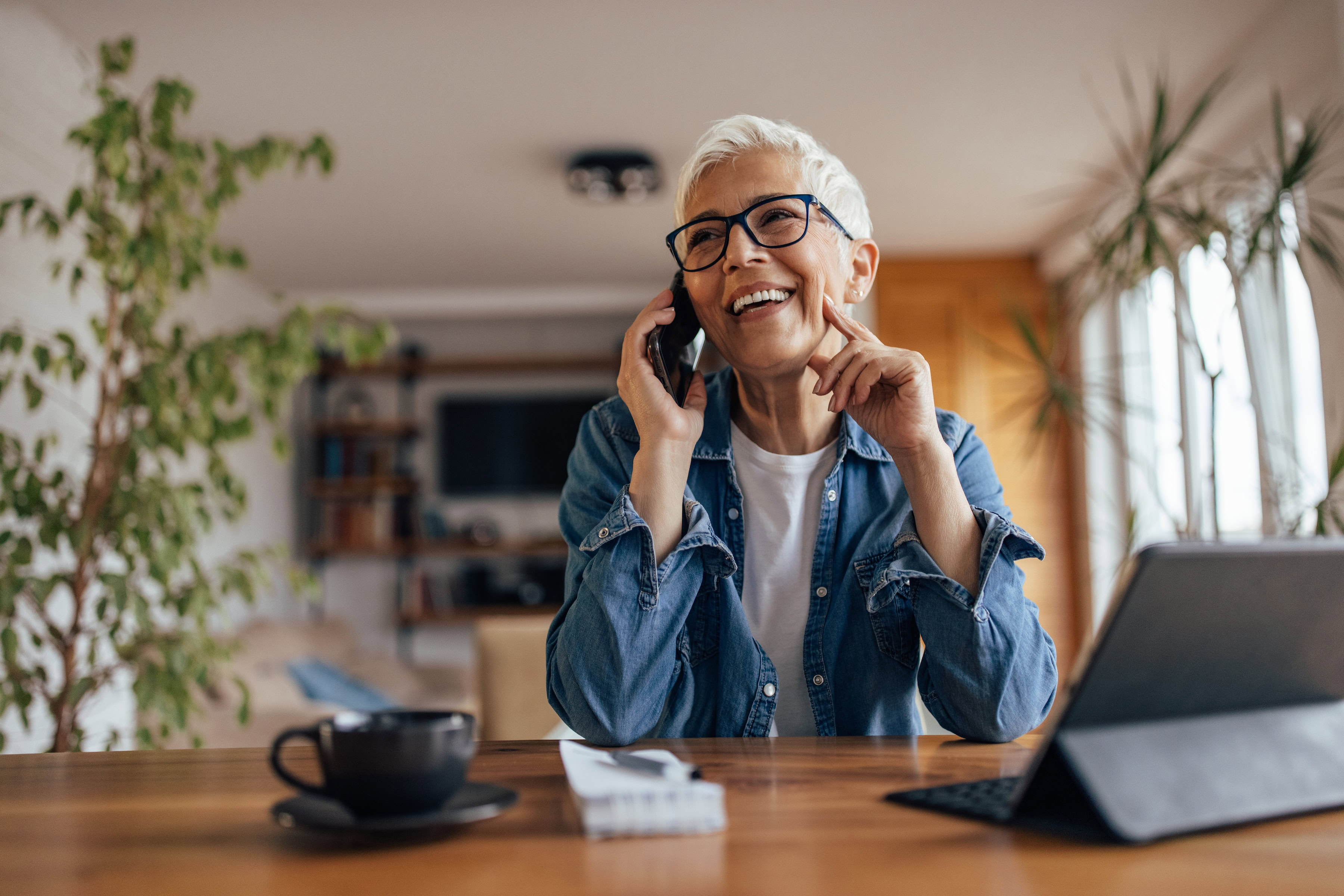 Happy mortgage customer talking on the phone to customer service