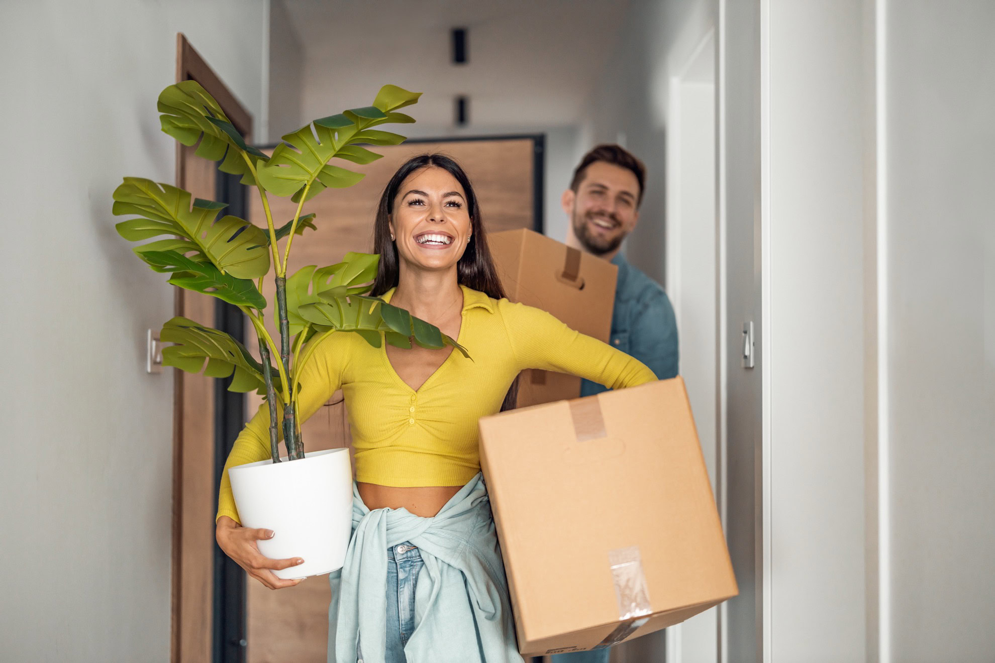 Young couple moving in new home.