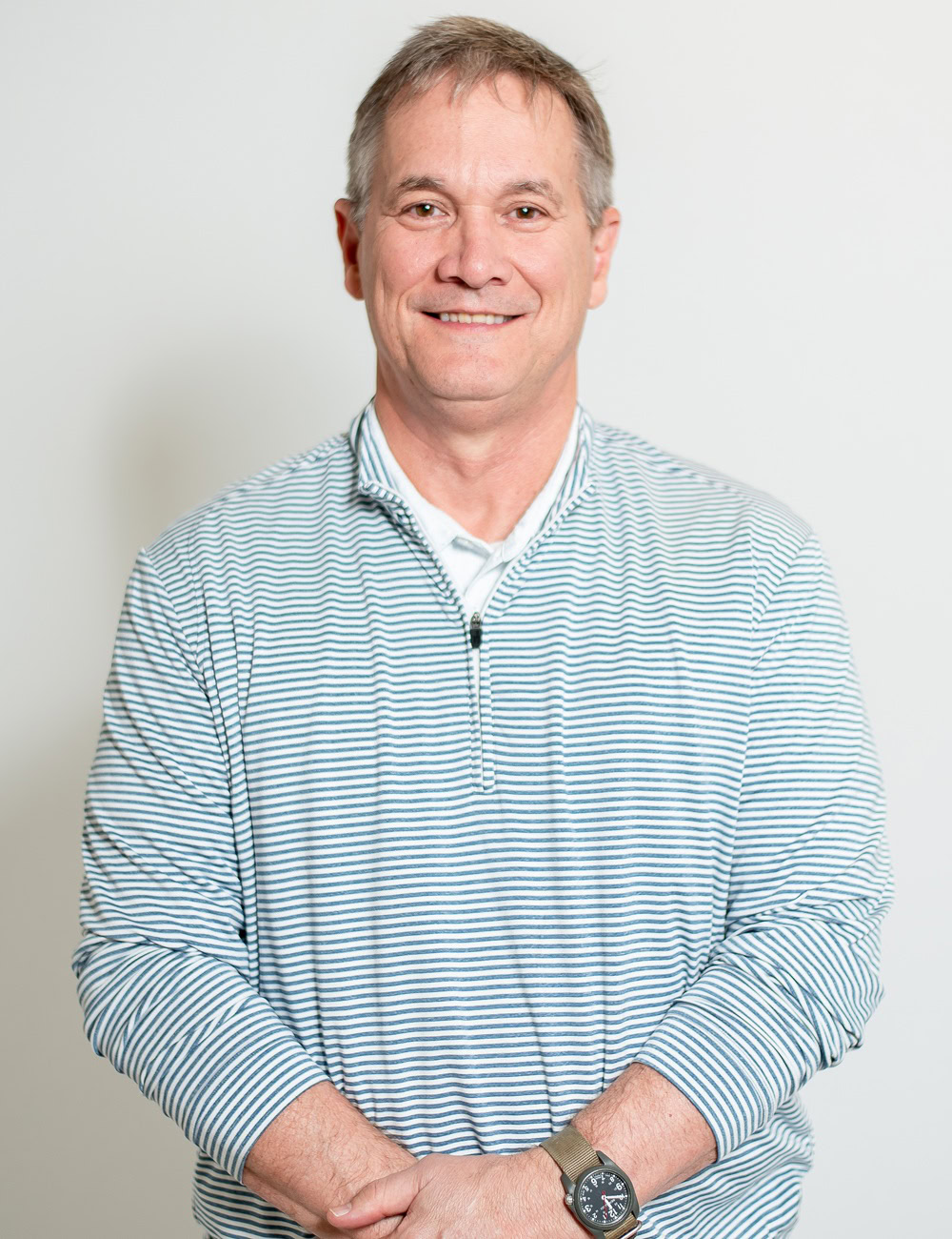 John Peterson, Mortgage Loan Officer, smiling in brown blazer.