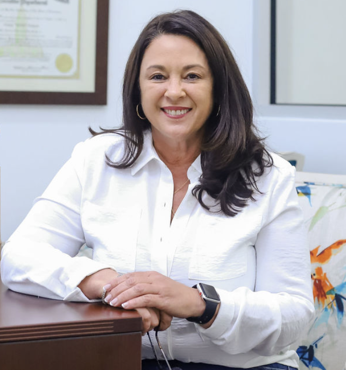 Aimia Doucet, Mortgage Loan Officer, smiling in white button down.