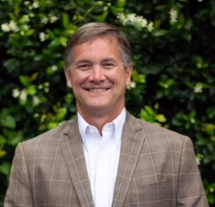 John Peterson, Mortgage Loan Officer, smiling in brown blazer.